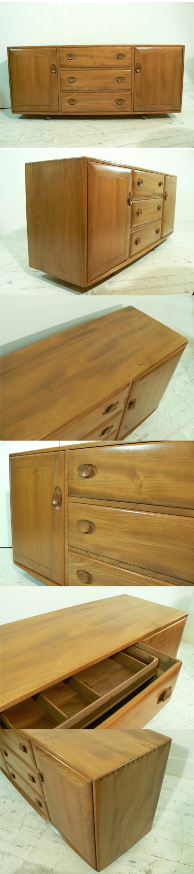 A large Ercol sideboard, c1960s. Made from solid elm and standing on castors.